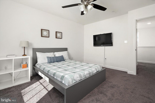 bedroom featuring ceiling fan and dark colored carpet