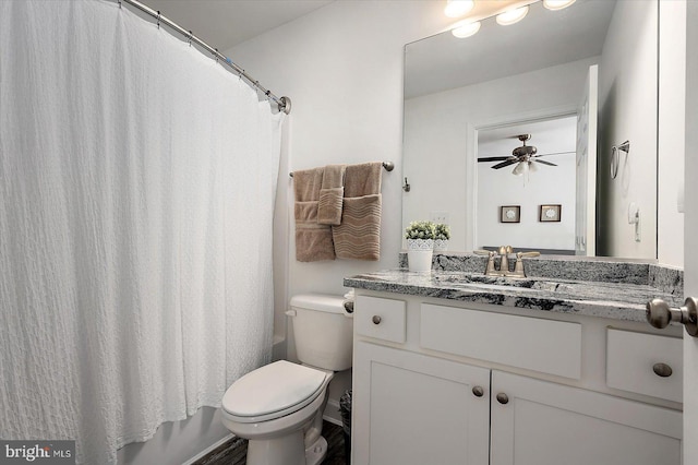 full bathroom featuring vanity, ceiling fan, shower / bath combo with shower curtain, and toilet