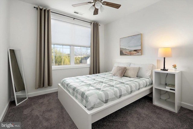 bedroom with ceiling fan and dark colored carpet