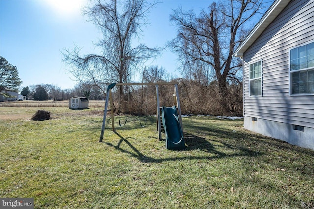 view of yard featuring a playground and a storage unit