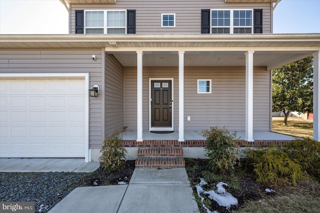 entrance to property featuring a garage and a porch