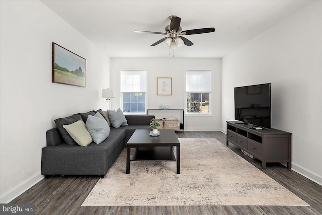 living room with dark hardwood / wood-style flooring and ceiling fan