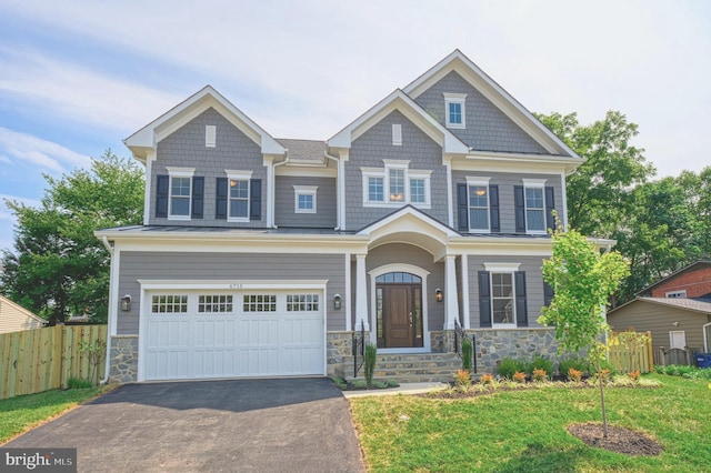 craftsman-style home with a garage and a front lawn