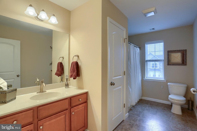 bathroom with tile patterned floors, vanity, and toilet