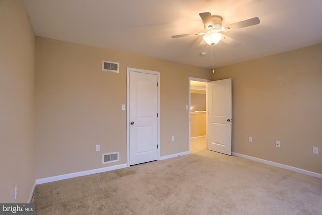 unfurnished bedroom featuring ceiling fan and light carpet