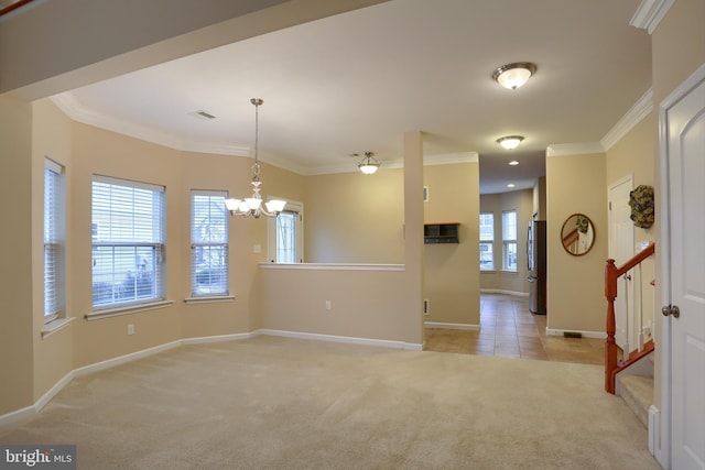 carpeted empty room with a notable chandelier and crown molding