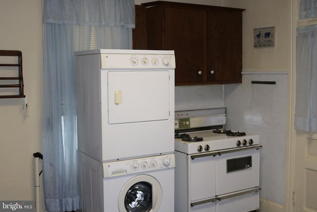 kitchen featuring range with two ovens, stacked washing maching and dryer, and dark brown cabinets