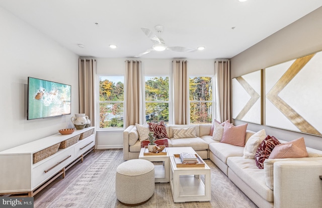 living room featuring hardwood / wood-style floors, plenty of natural light, and ceiling fan