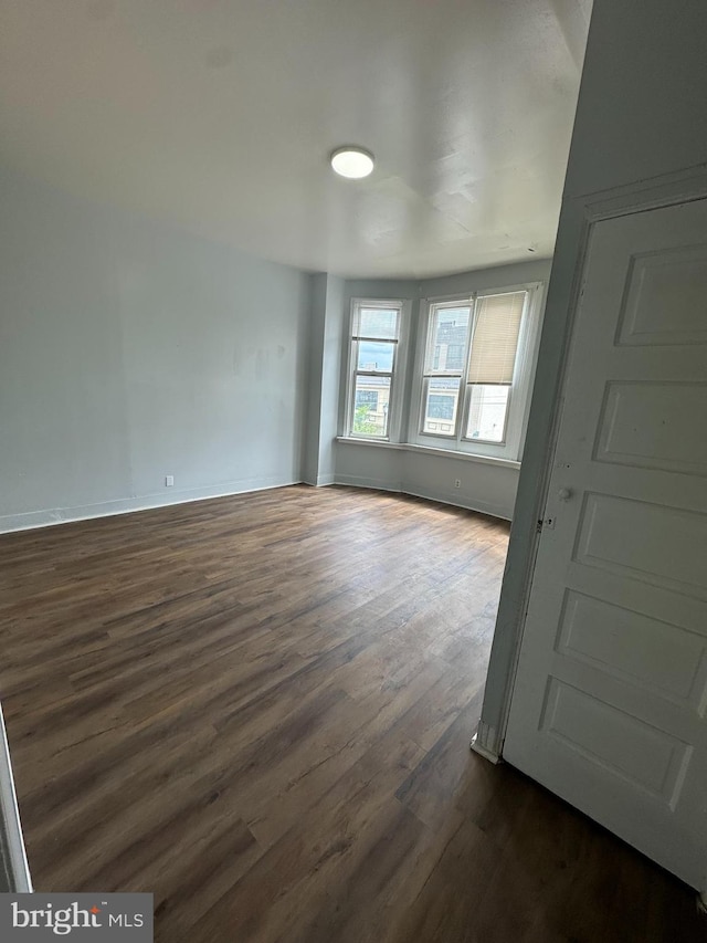 empty room featuring dark wood-type flooring