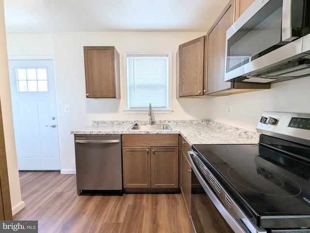 kitchen featuring sink, hardwood / wood-style flooring, and appliances with stainless steel finishes