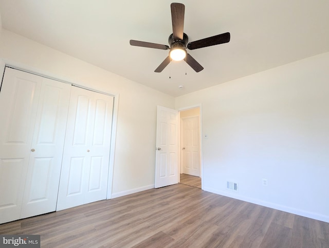 unfurnished bedroom with a closet, ceiling fan, and light wood-type flooring