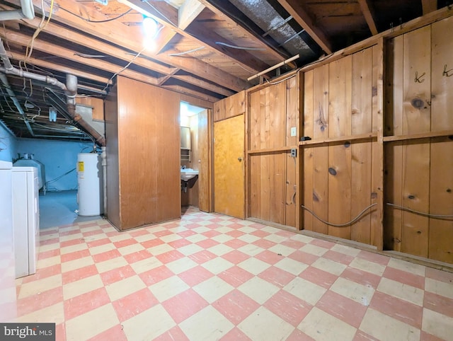 basement featuring independent washer and dryer and water heater