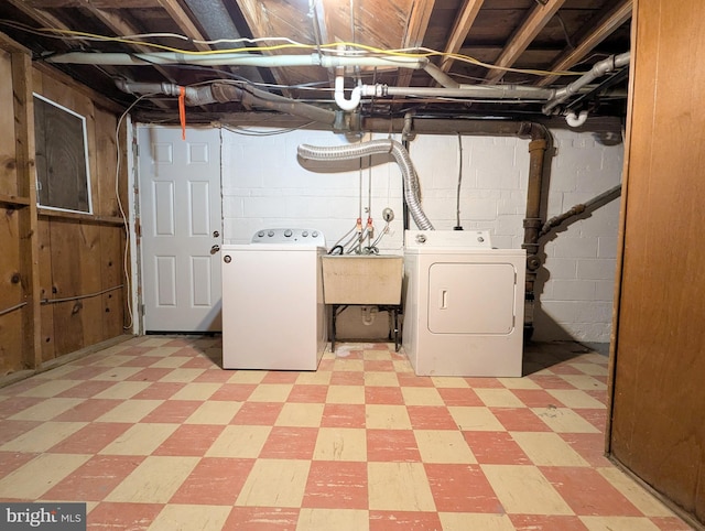 basement with sink and washer and clothes dryer