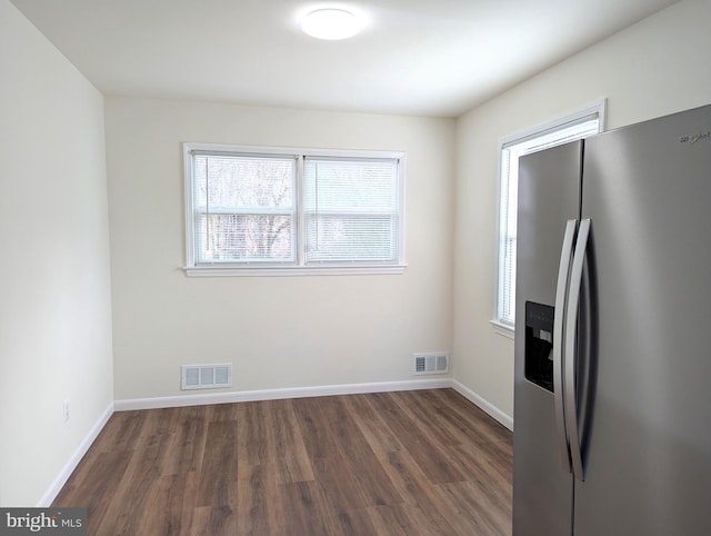 kitchen featuring dark hardwood / wood-style floors and stainless steel fridge with ice dispenser