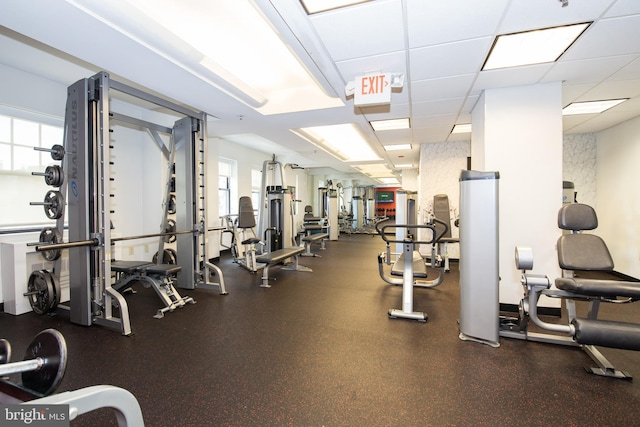 exercise room with a drop ceiling and plenty of natural light