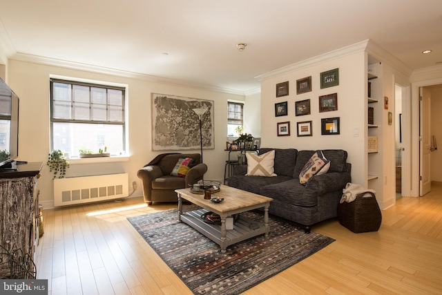 living room with crown molding, radiator, and hardwood / wood-style floors