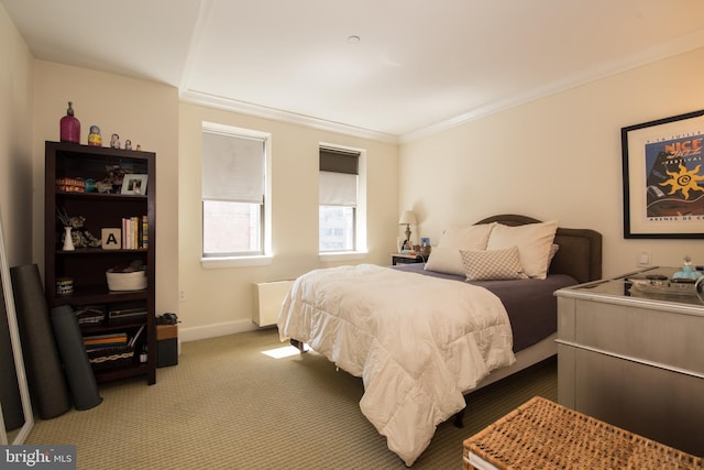 carpeted bedroom featuring crown molding