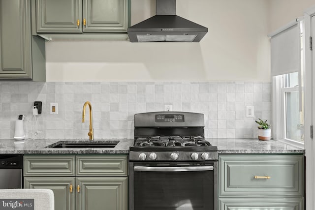 kitchen featuring light stone counters, sink, gas range, and exhaust hood