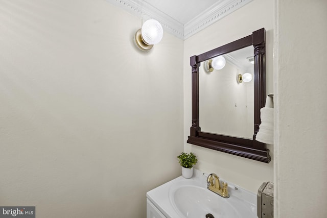 bathroom with ornamental molding and vanity