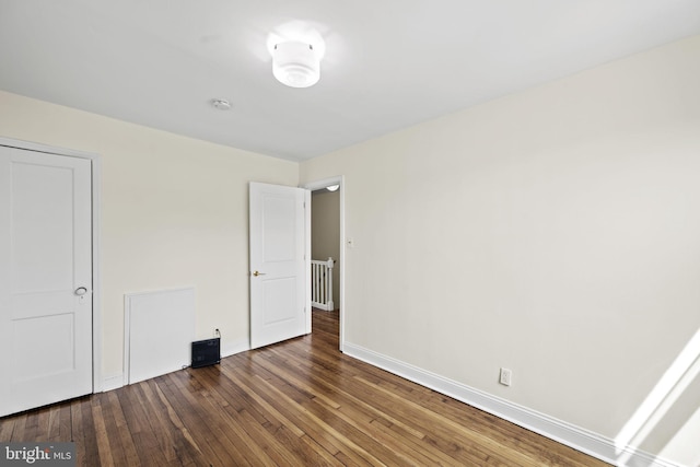 unfurnished bedroom featuring dark hardwood / wood-style floors