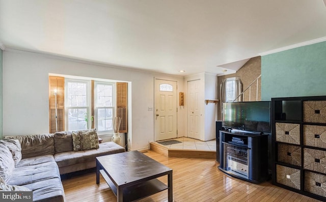 living room featuring crown molding and light wood-type flooring