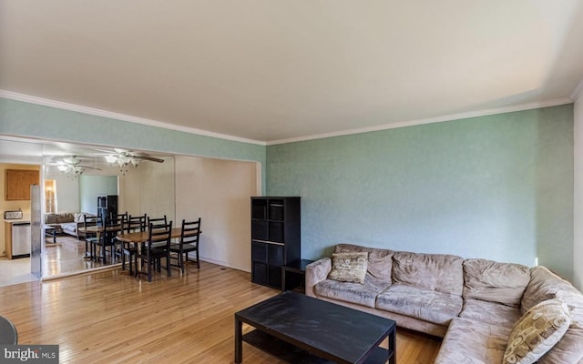 living room featuring crown molding, wood-type flooring, and ceiling fan