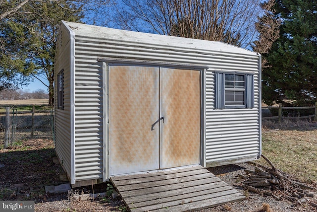 view of shed featuring fence