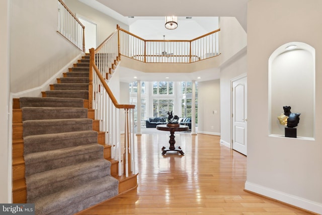 foyer featuring hardwood / wood-style flooring and a high ceiling