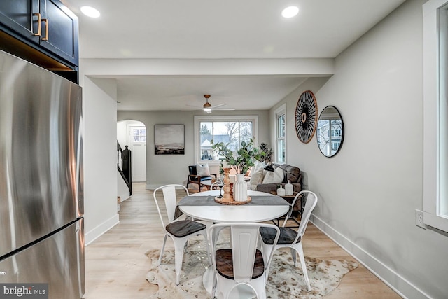 dining area with ceiling fan and light wood-type flooring