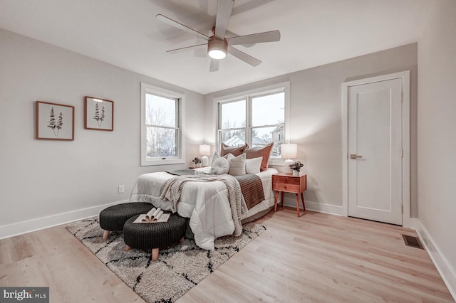 bedroom with ceiling fan and light hardwood / wood-style flooring