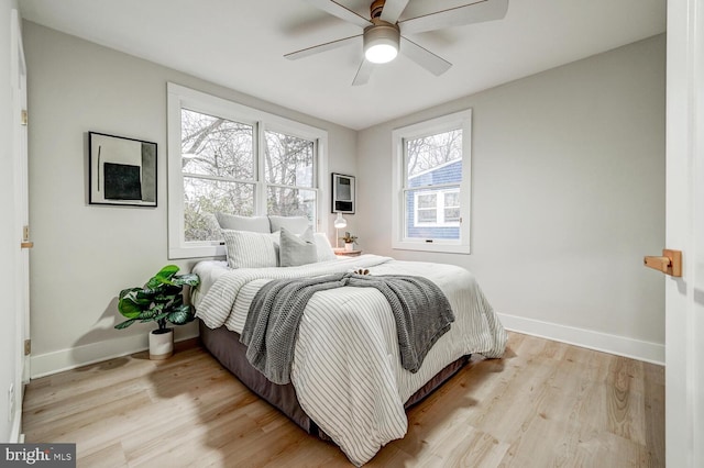 bedroom with light hardwood / wood-style floors and ceiling fan