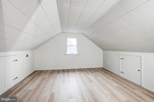 bonus room with vaulted ceiling and light hardwood / wood-style floors