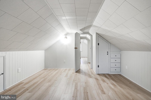 bonus room with lofted ceiling and light hardwood / wood-style flooring