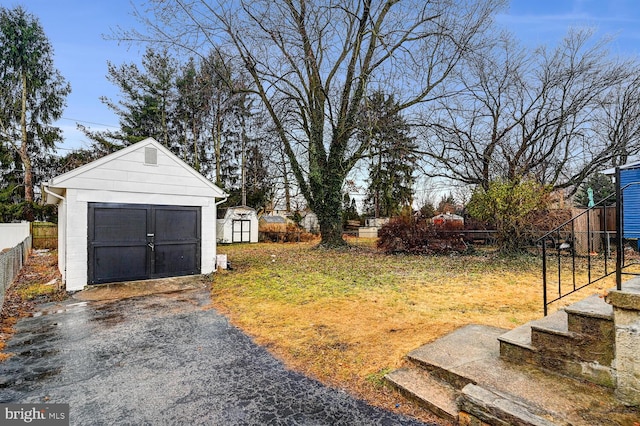 view of yard with a garage and a storage unit