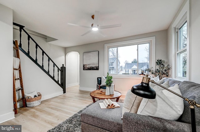 living room with ceiling fan and light hardwood / wood-style floors