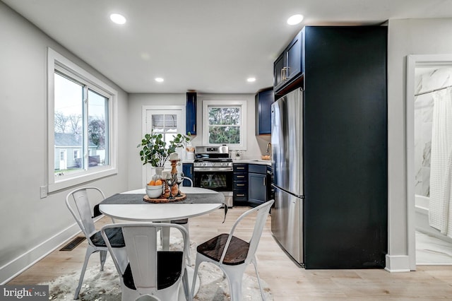 dining area with plenty of natural light and light wood-type flooring