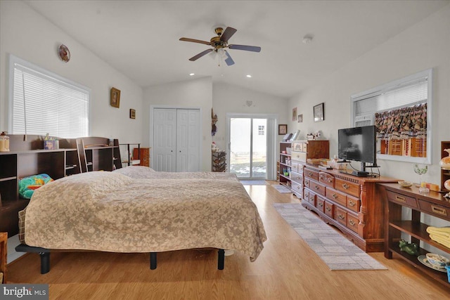 bedroom with ceiling fan, light hardwood / wood-style floors, vaulted ceiling, and a closet