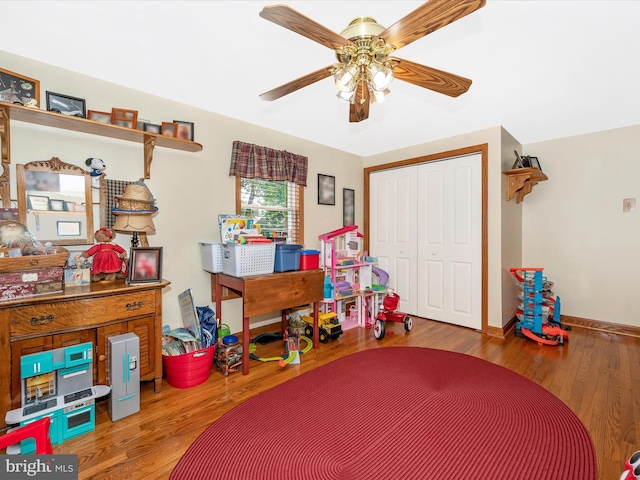 playroom with ceiling fan and wood-type flooring