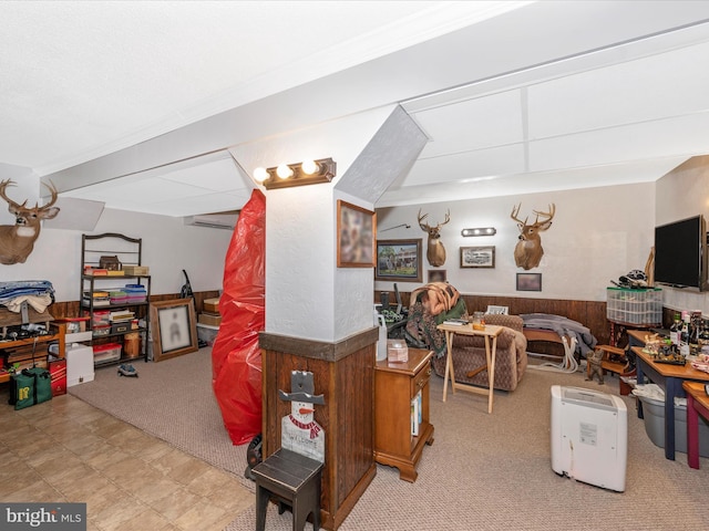 interior space with a wall mounted air conditioner, light colored carpet, and wood walls