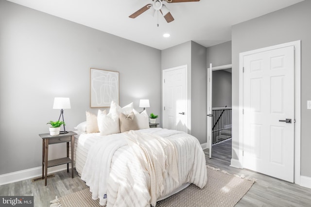 bedroom featuring ceiling fan and light hardwood / wood-style flooring