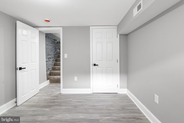 basement with light hardwood / wood-style floors