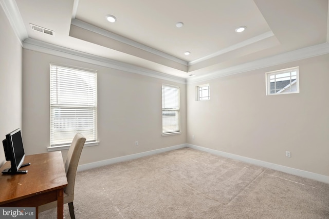 office space with crown molding, light colored carpet, and a tray ceiling