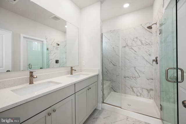 bathroom featuring vanity and a shower with door