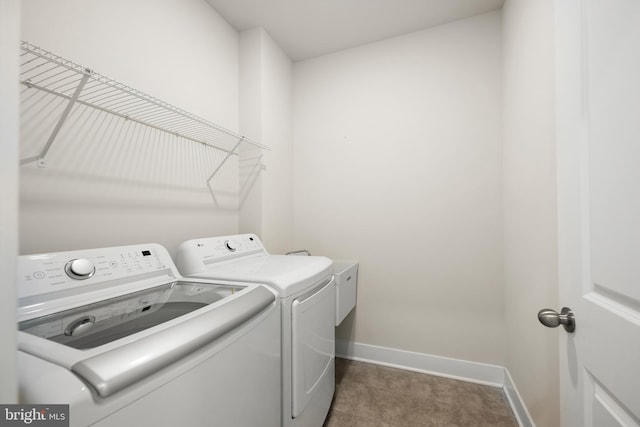 clothes washing area with washing machine and clothes dryer