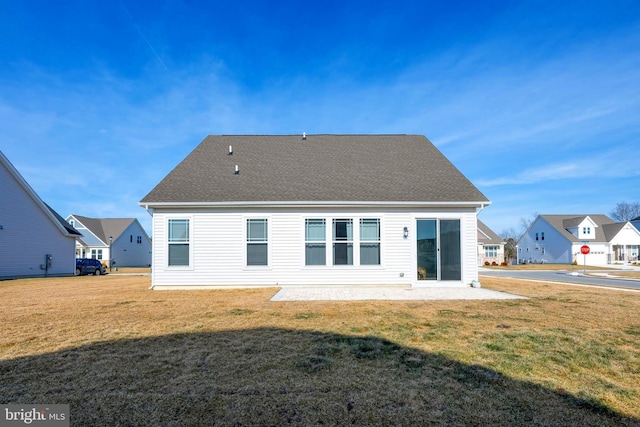 back of property with a patio area and a lawn