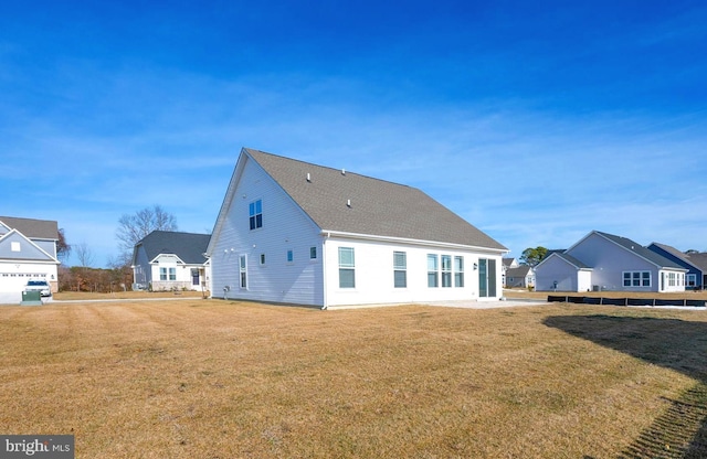 rear view of house featuring a yard