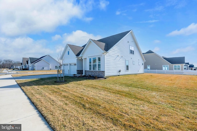 view of side of home with a garage and a lawn