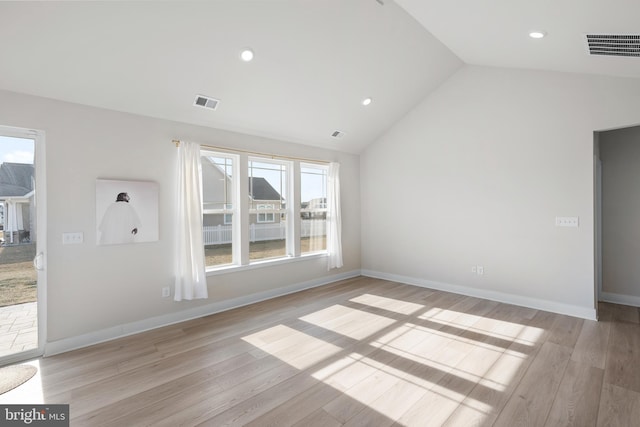 unfurnished living room with lofted ceiling and light wood-type flooring