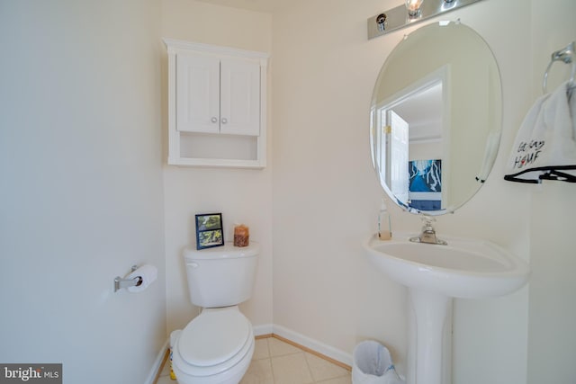 bathroom featuring tile patterned floors, toilet, and sink