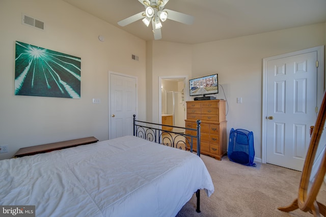 bedroom with ceiling fan, light colored carpet, and lofted ceiling